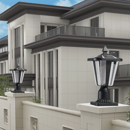 Black square craftsman solar pillar light on a stone gate post outside a modern house in daylight